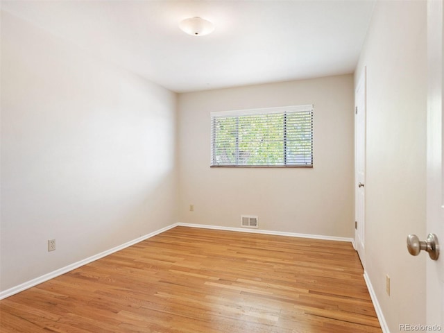 spare room with light hardwood / wood-style floors