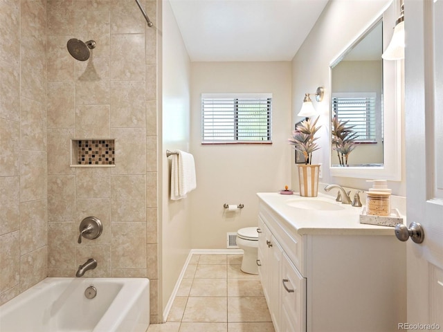 full bathroom featuring vanity, tile patterned flooring, tiled shower / bath combo, and toilet