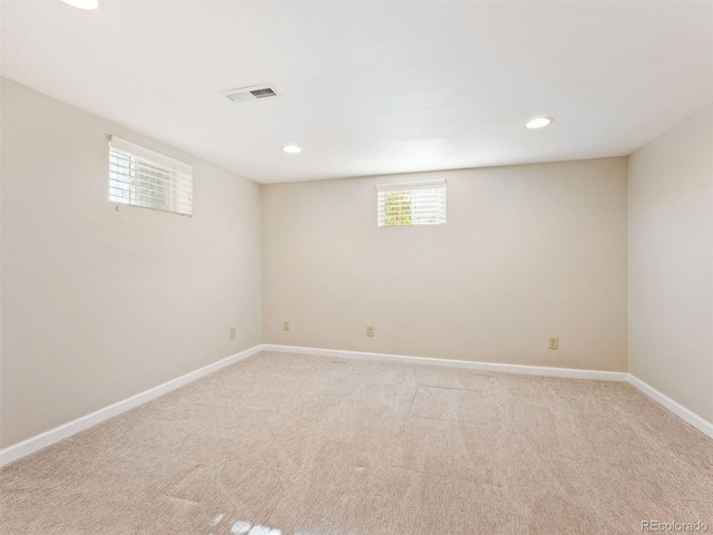 basement featuring light carpet