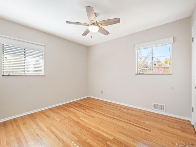 spare room with hardwood / wood-style flooring and ceiling fan