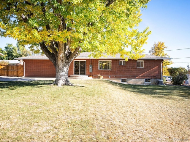 rear view of house featuring a lawn