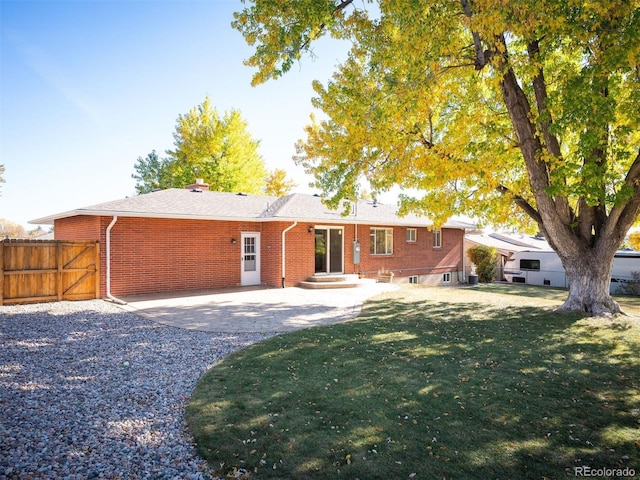 back of house featuring a yard and a patio