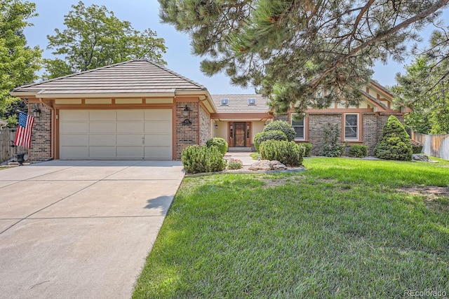 view of front of home with a front yard and a garage