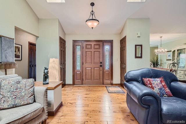 entrance foyer featuring a notable chandelier and light hardwood / wood-style floors