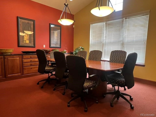 dining room featuring lofted ceiling and carpet flooring