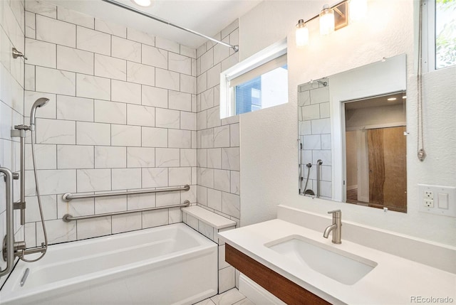 bathroom with tiled shower / bath and vanity