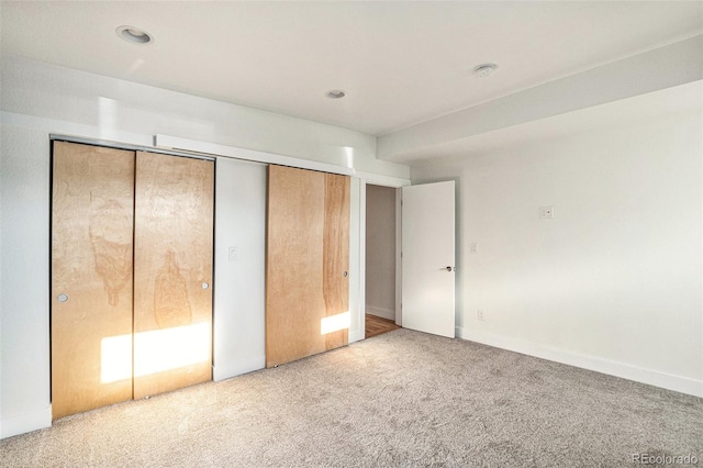 unfurnished bedroom with carpet flooring and a closet