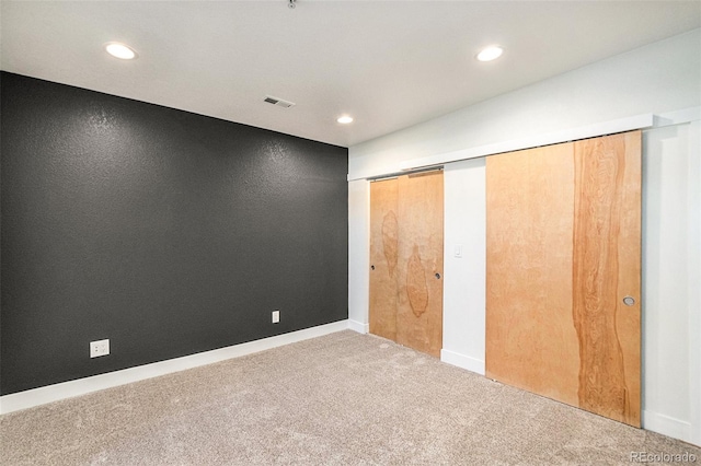 unfurnished bedroom with carpet and a closet