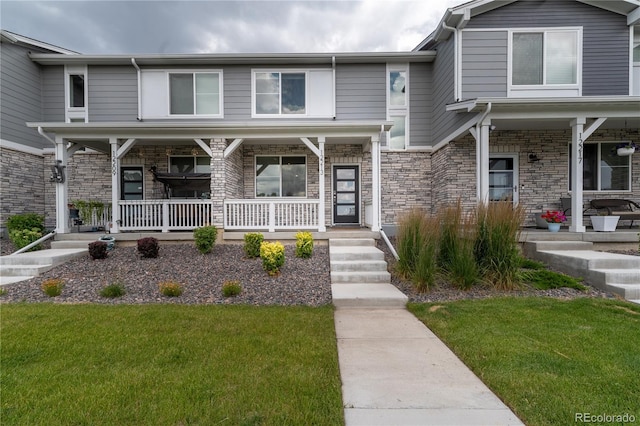 12213 Race St, Northglenn, CO 80241 - multi unit property with a porch, a front lawn, and stone siding