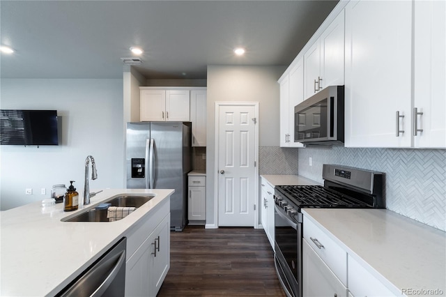12213 Race St, Northglenn, CO 80241 - kitchen with stainless steel appliances, white cabinetry, light countertops, and recessed lighting