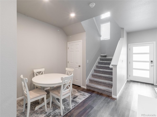 12213 Race St, Northglenn, CO 80241 - dining space with wood finished floors, stairs, healthy amount of natural light, and vaulted ceiling