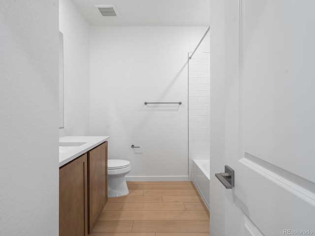 full bathroom with toilet, wood finished floors, vanity, visible vents, and baseboards