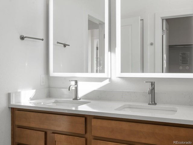 full bath with double vanity and a sink