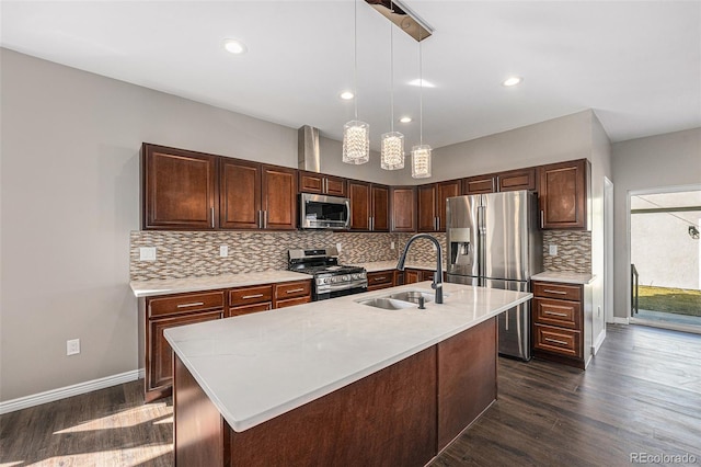 kitchen with a sink, light countertops, dark wood-type flooring, and stainless steel appliances