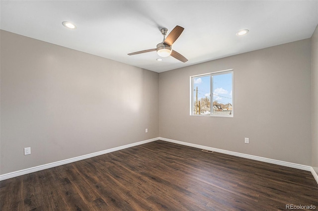 spare room featuring recessed lighting, visible vents, baseboards, and dark wood-style floors