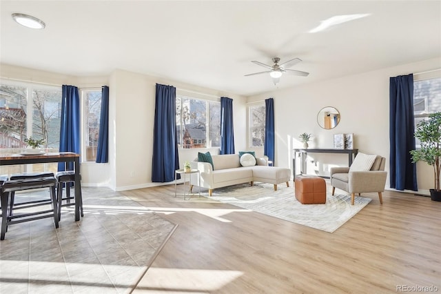 4844 Mt Evans St, Brighton, CO 80601 - living room featuring plenty of natural light, a ceiling fan, and baseboards
