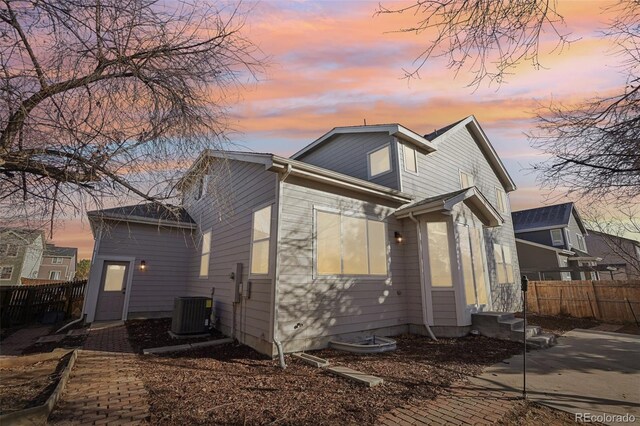 4844 Mt Evans St, Brighton, CO 80601 - back of property at dusk featuring cooling unit