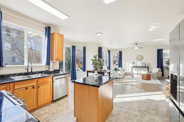 4844 Mt Evans St, Brighton, CO 80601 - kitchen with stainless steel dishwasher, a sink, a kitchen island, and healthy amount of natural light