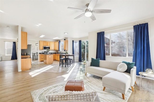 4844 Mt Evans St, Brighton, CO 80601 - living room featuring light wood-type flooring and ceiling fan