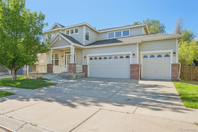4844 Mt Evans St, Brighton, CO 80601 - view of front of house featuring brick siding, an attached garage, driveway, and a porch