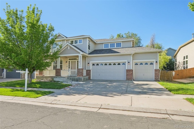 4844 Mt Evans St, Brighton, CO 80601 - view of front facade with brick siding, an attached garage, driveway, and covered porch