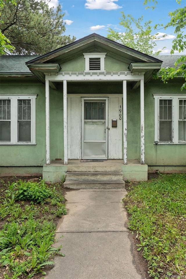 1900 S University Blvd, Denver, CO 80210 - view of exterior entry with stucco siding and a porch