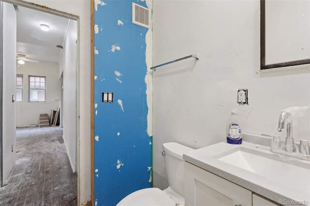 1900 S University Blvd, Denver, CO 80210 - bathroom featuring vanity, toilet, and ceiling fan