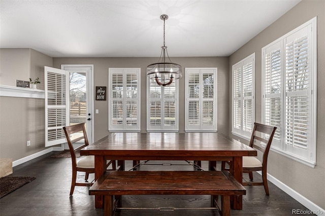 dining area featuring dark wood-style floors, plenty of natural light, and baseboards