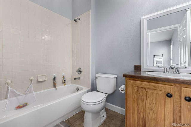 full bath with tile patterned flooring, toilet, vanity, baseboards, and washtub / shower combination