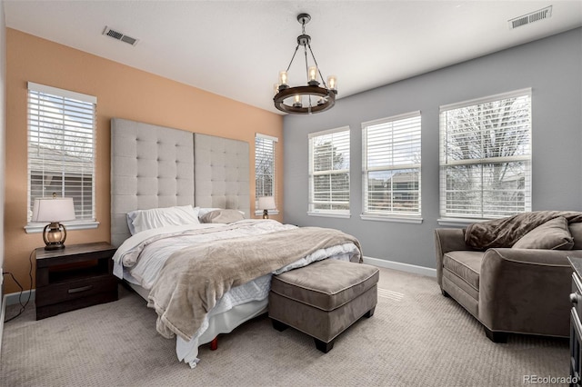 bedroom featuring visible vents, light carpet, and multiple windows