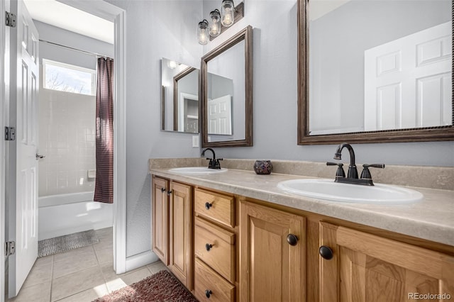 bathroom featuring double vanity, shower / bath combination with curtain, tile patterned flooring, and a sink