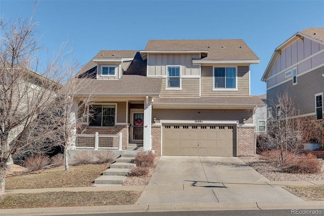 view of front of house with a porch, an attached garage, brick siding, concrete driveway, and board and batten siding