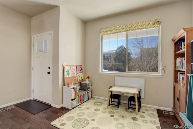 entrance foyer with dark wood-style flooring, visible vents, and baseboards