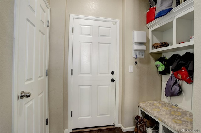 mudroom featuring baseboards and a textured wall