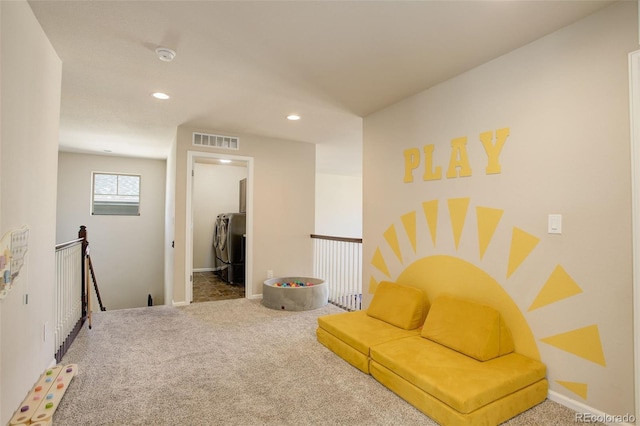 sitting room with recessed lighting, visible vents, carpet flooring, and an upstairs landing