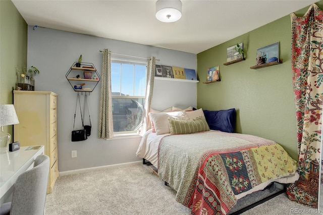 carpeted bedroom featuring baseboards