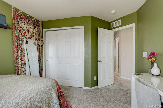 bedroom featuring baseboards, a closet, visible vents, and carpet flooring