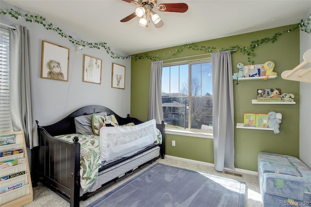 bedroom with ceiling fan, carpet floors, visible vents, and baseboards