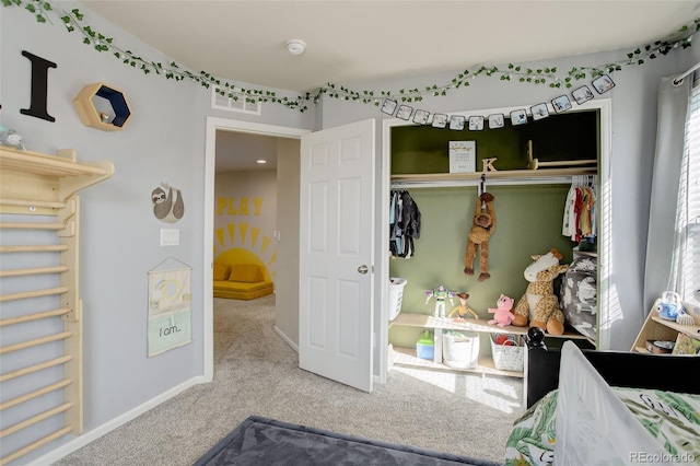 bedroom with carpet floors, baseboards, visible vents, and a closet