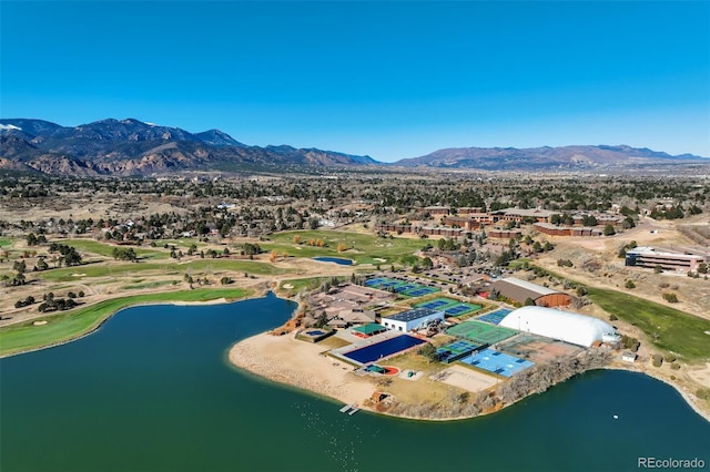 birds eye view of property with a water and mountain view