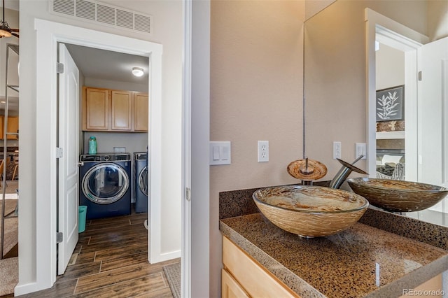 bathroom with washing machine and dryer and sink