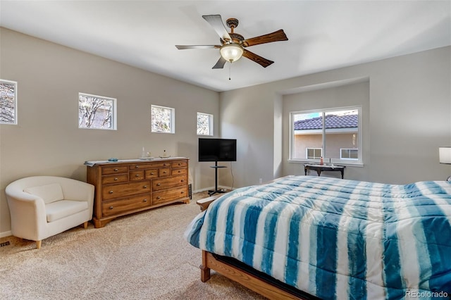 bedroom featuring ceiling fan and light carpet