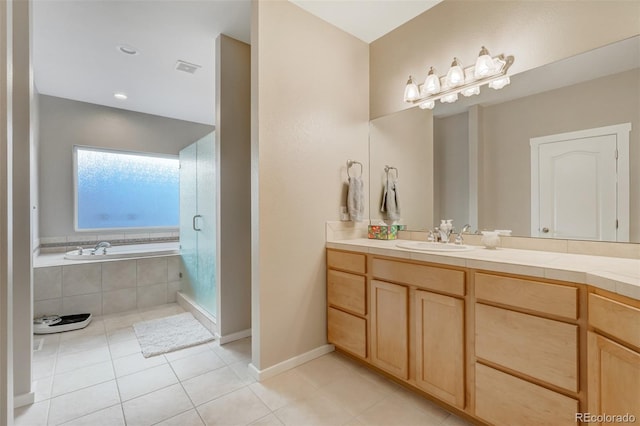 bathroom with tile patterned floors, vanity, and independent shower and bath