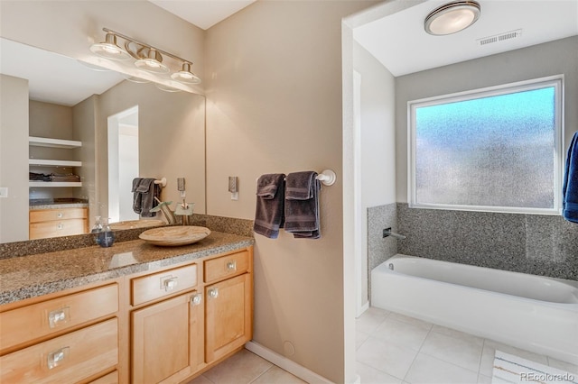 bathroom featuring tile patterned flooring, vanity, and a washtub