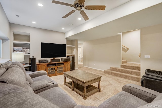 carpeted living room with ceiling fan and built in features