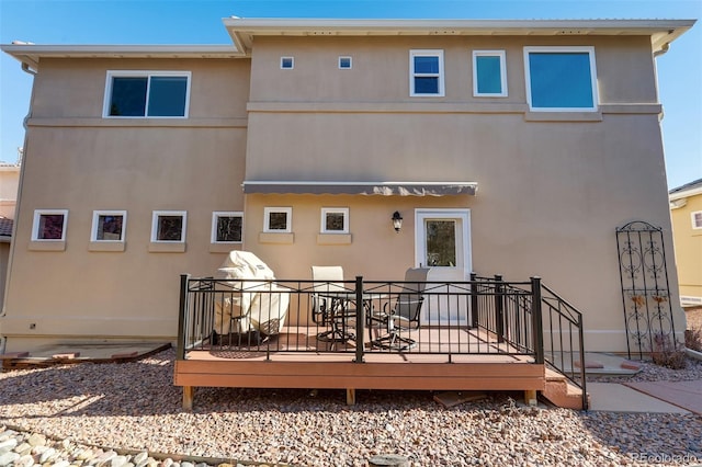 back of house featuring a wooden deck