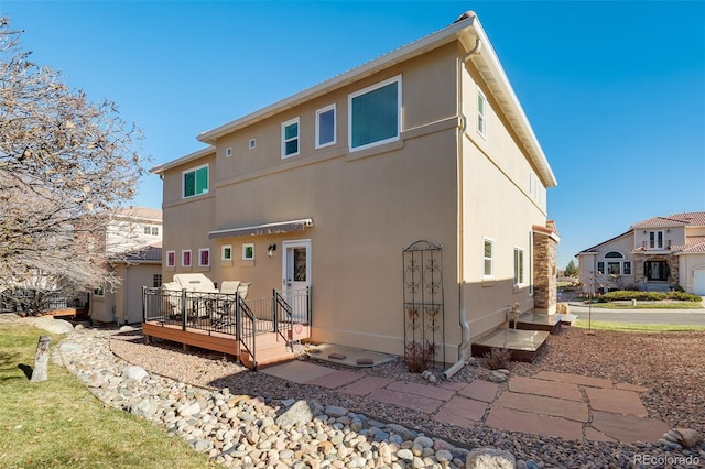 rear view of property with a deck