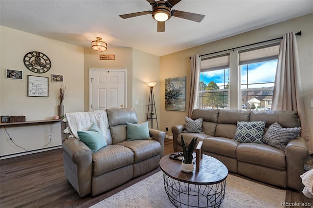 living room featuring ceiling fan and dark hardwood / wood-style floors