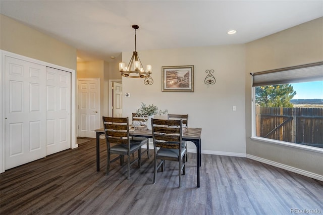 dining room featuring dark hardwood / wood-style flooring and a chandelier