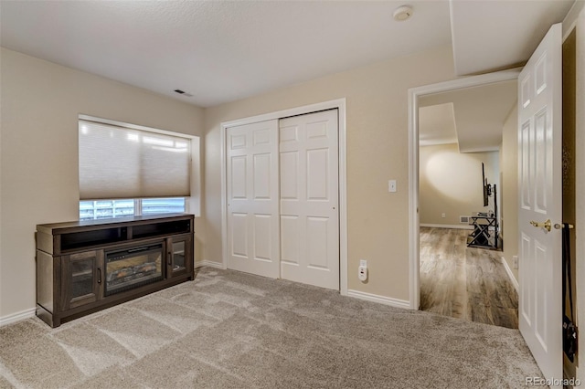 bedroom with light colored carpet and a closet